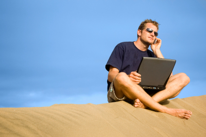 a man talking on the phone at the beach