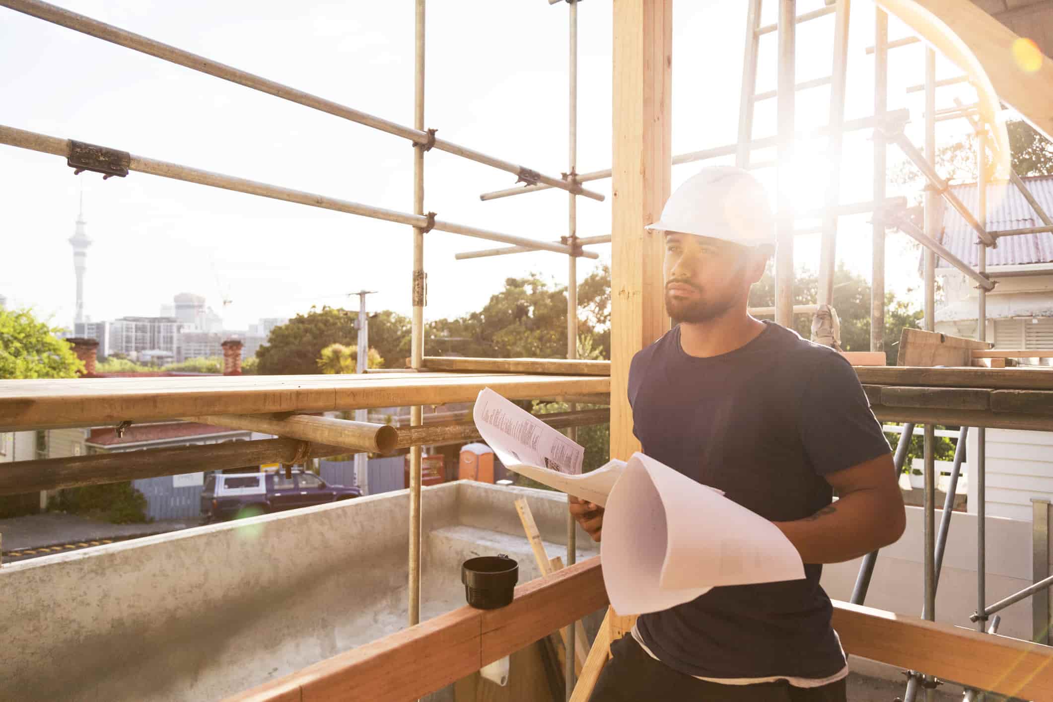 construction worker looking at the building plans