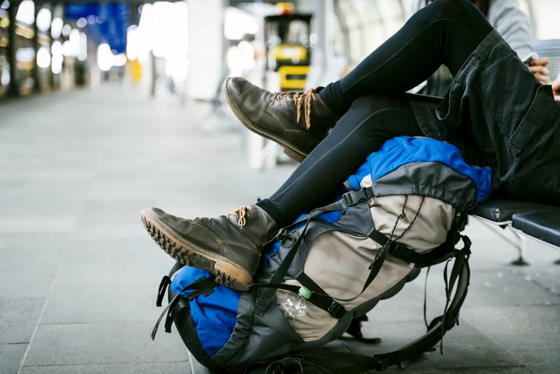 legs and rucksack of a young backpacker on a trip