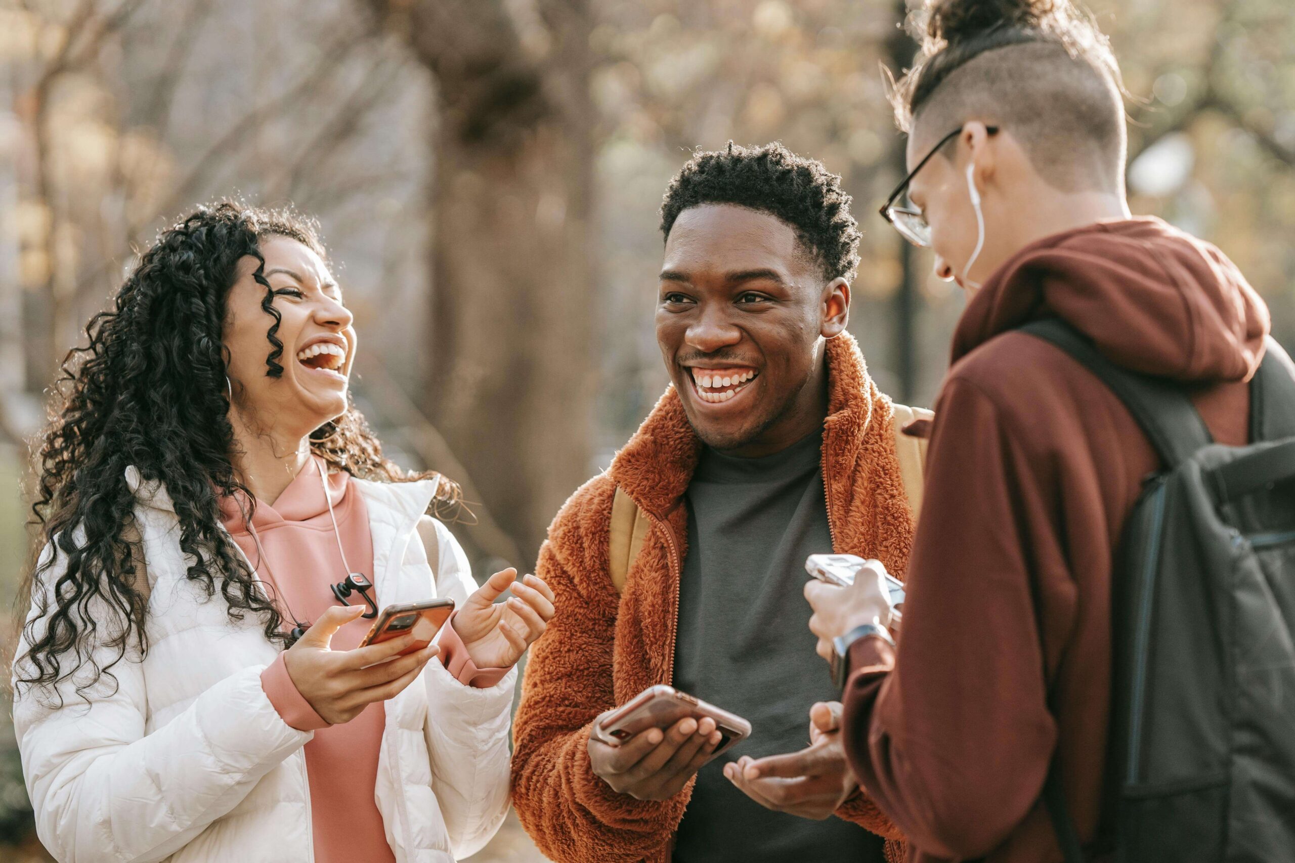 a group of friends holding their phones