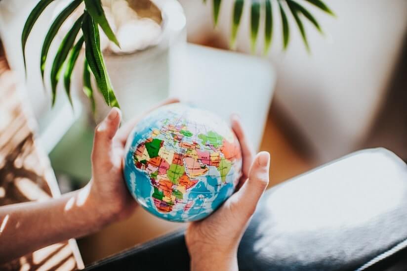 person holding a world globe map