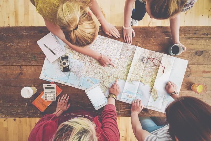 a group of friends exploring the map of the world