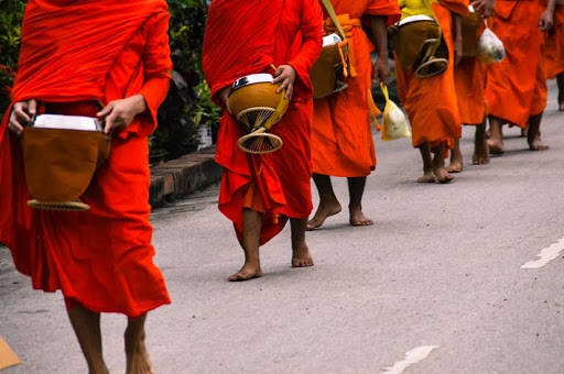 March in Laos, people dressed in red with drums