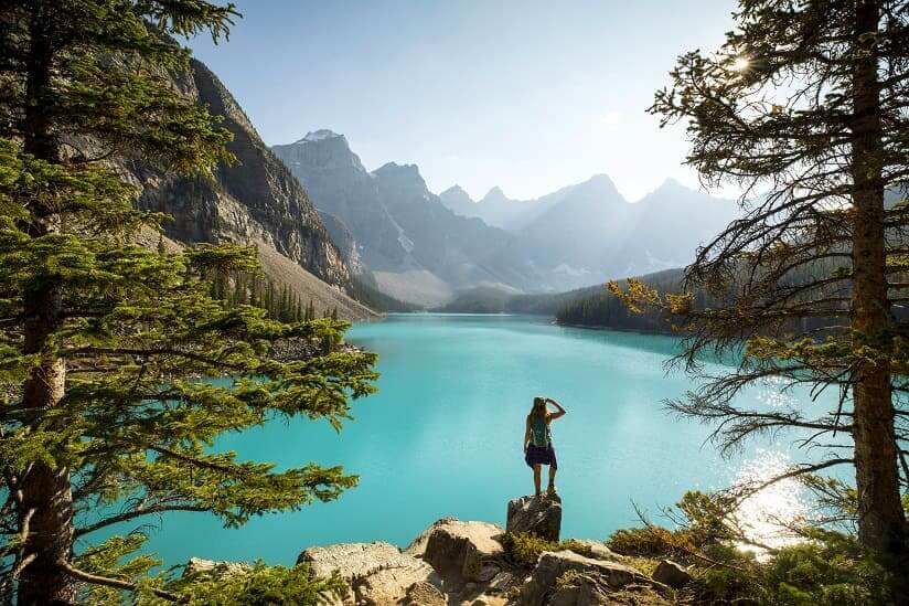 a tourist looking at a lake in Canada