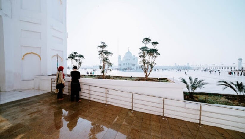 a couple standing on a balcony and looking at a landscape in Pakistan