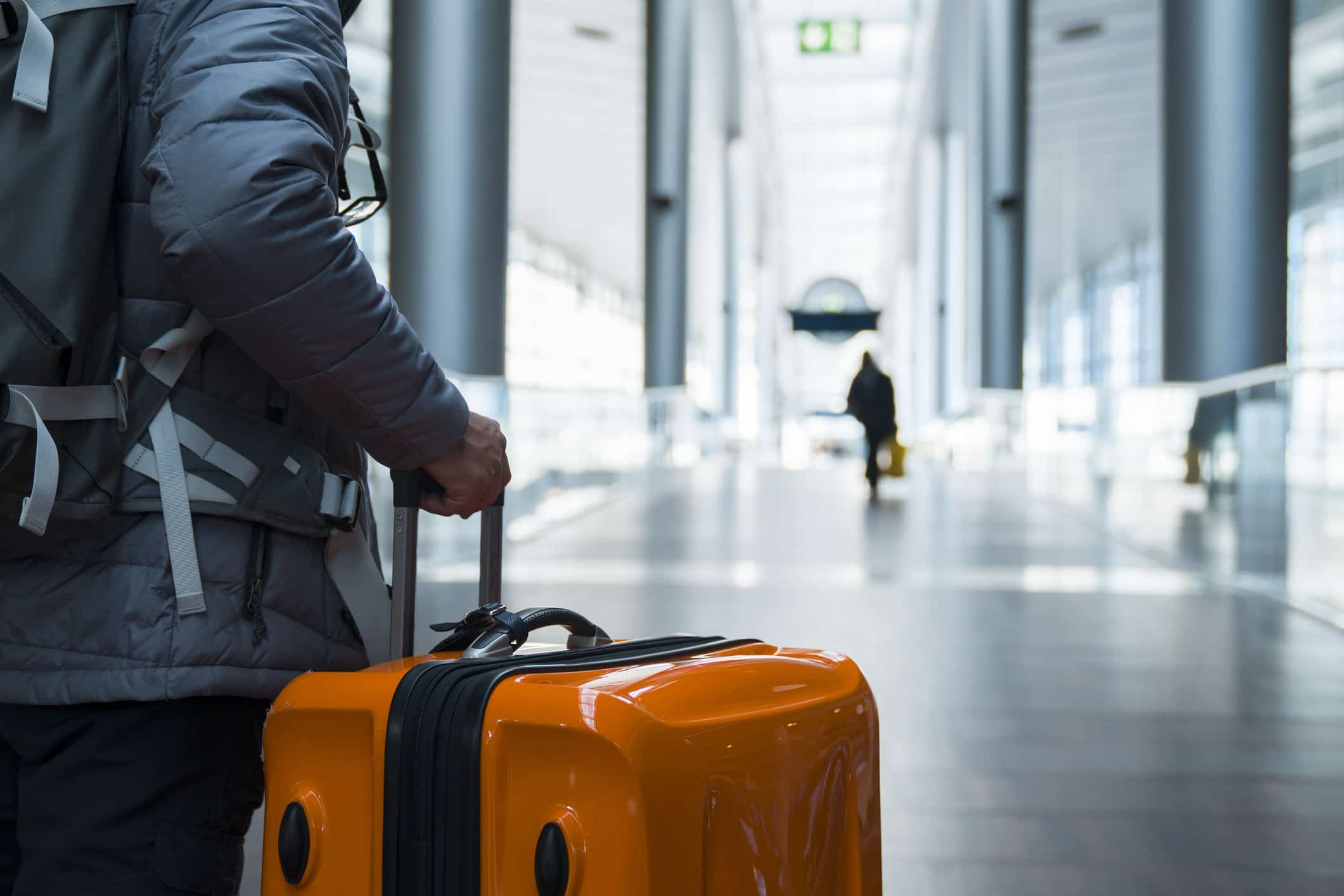 Person carrying his suitcase at an airport