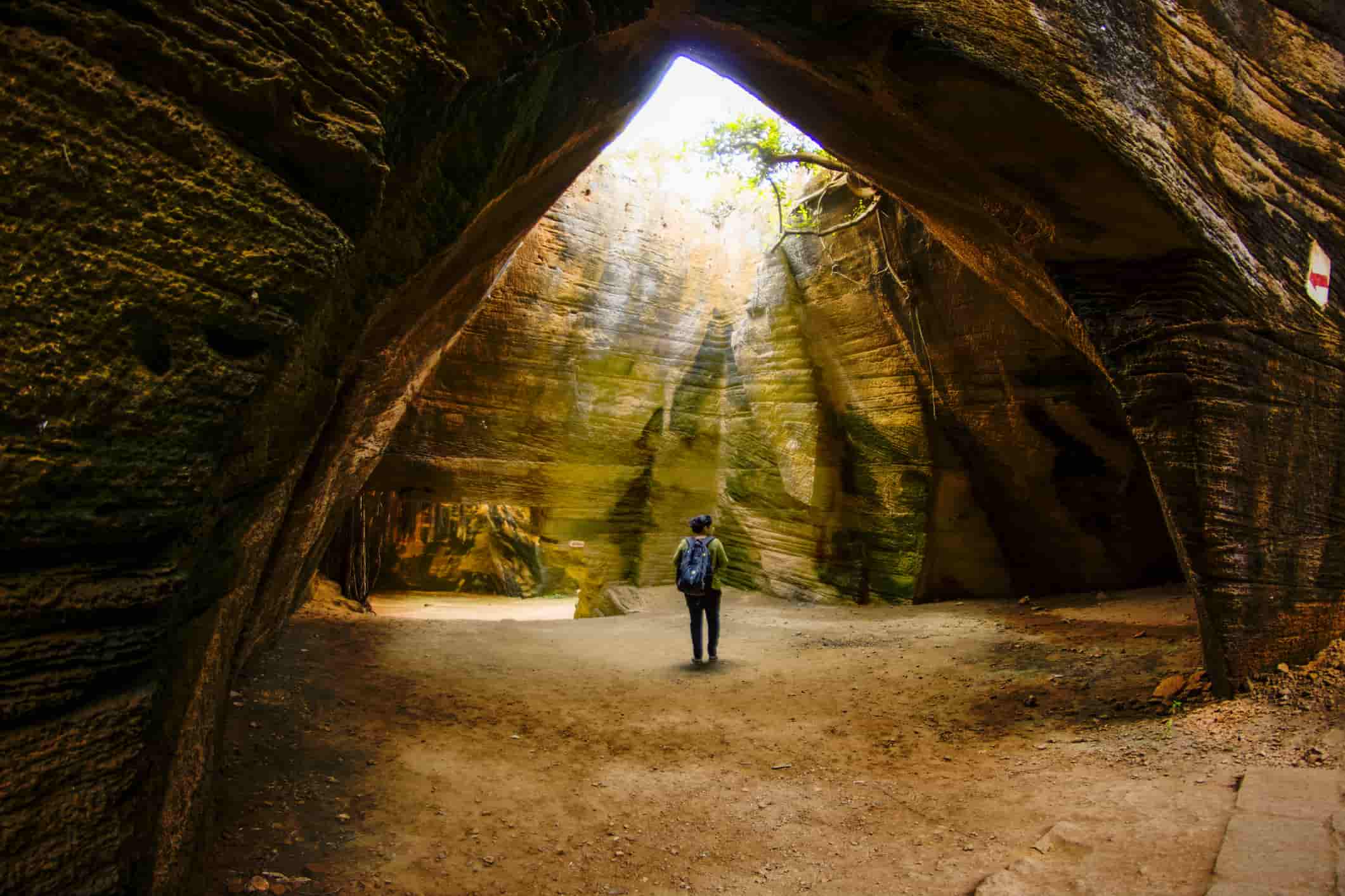 young woman visiting Naida Caves Diu in India