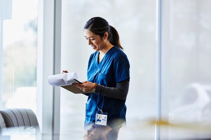 healthcare assistant looking at important documents