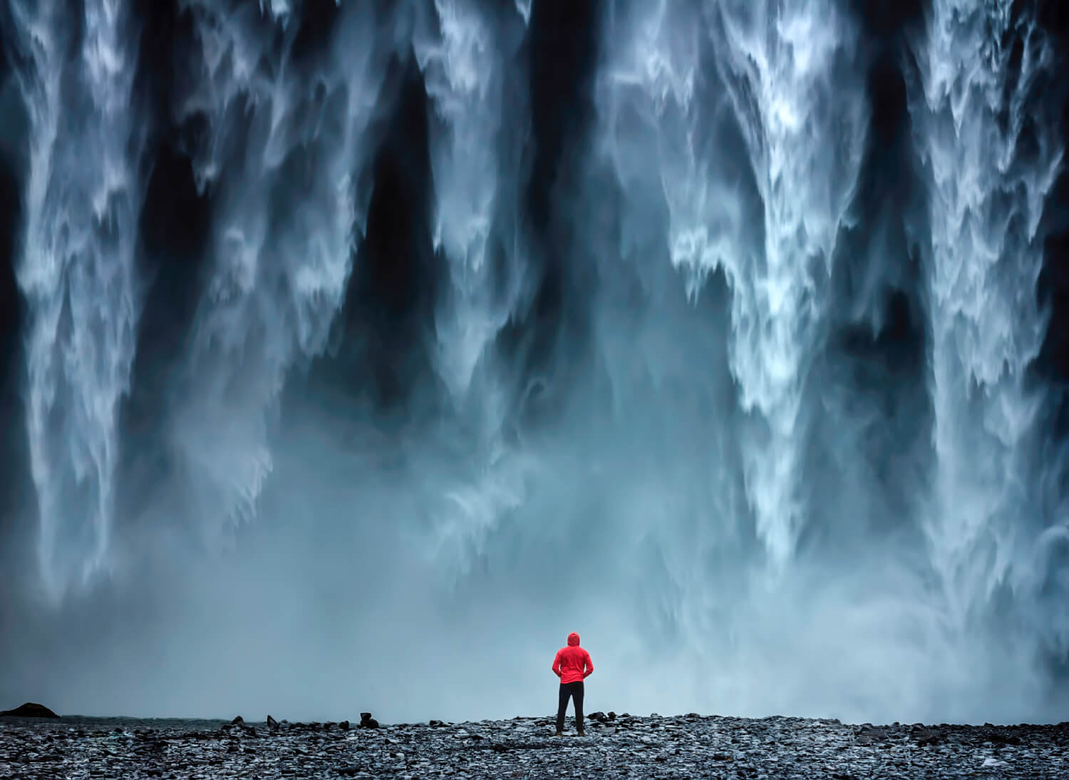 a man standing in front of the Langjokull Glacier in Iceland