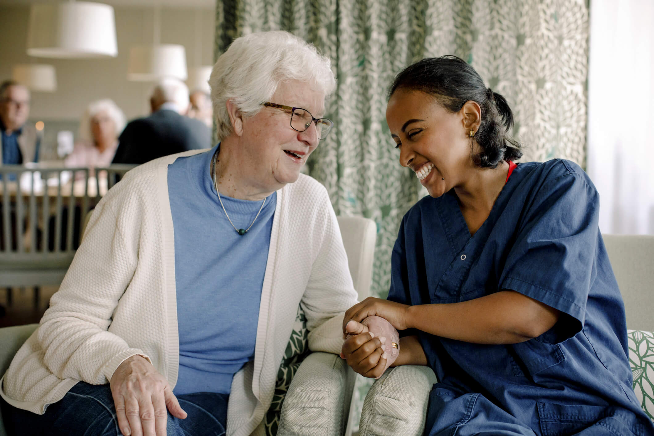 a healthcare assistant communicating with another lady