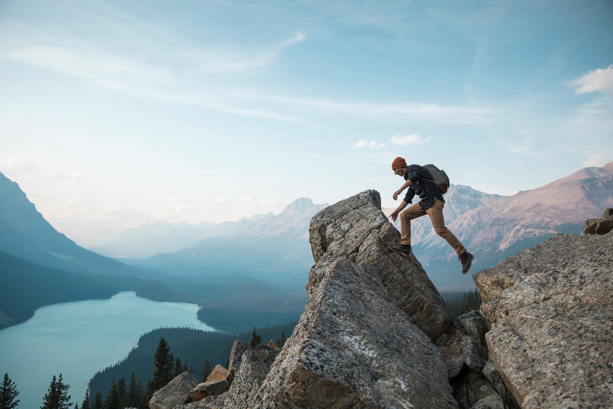 a man standing on a rock overlooking Peyto Lake