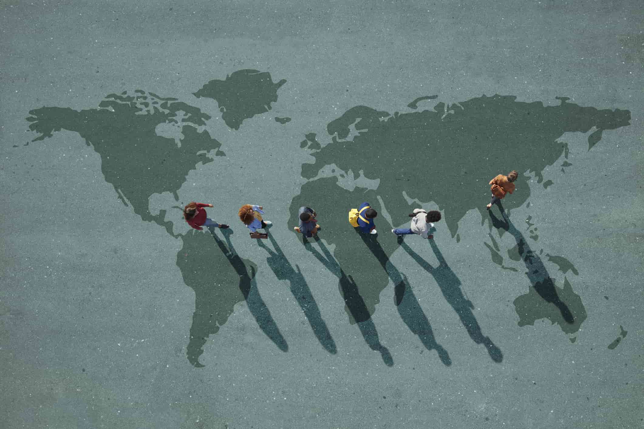 people walking across the world map