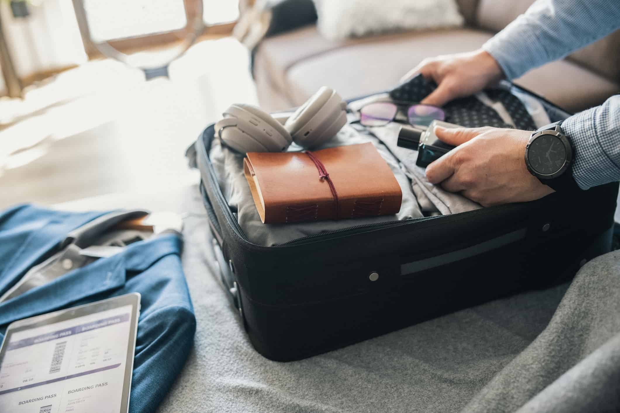 a person packing a suitcase for a business trip
