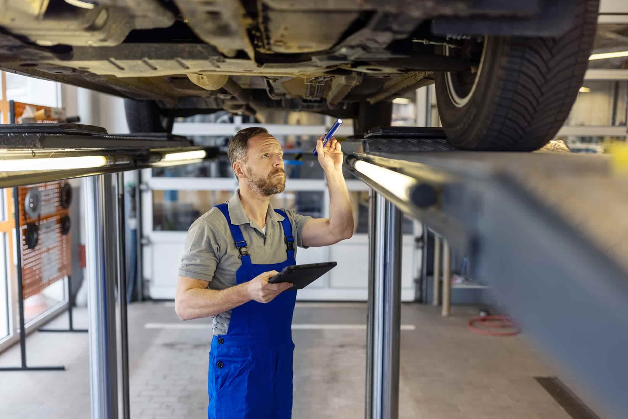 car mechanic working on fixing a car