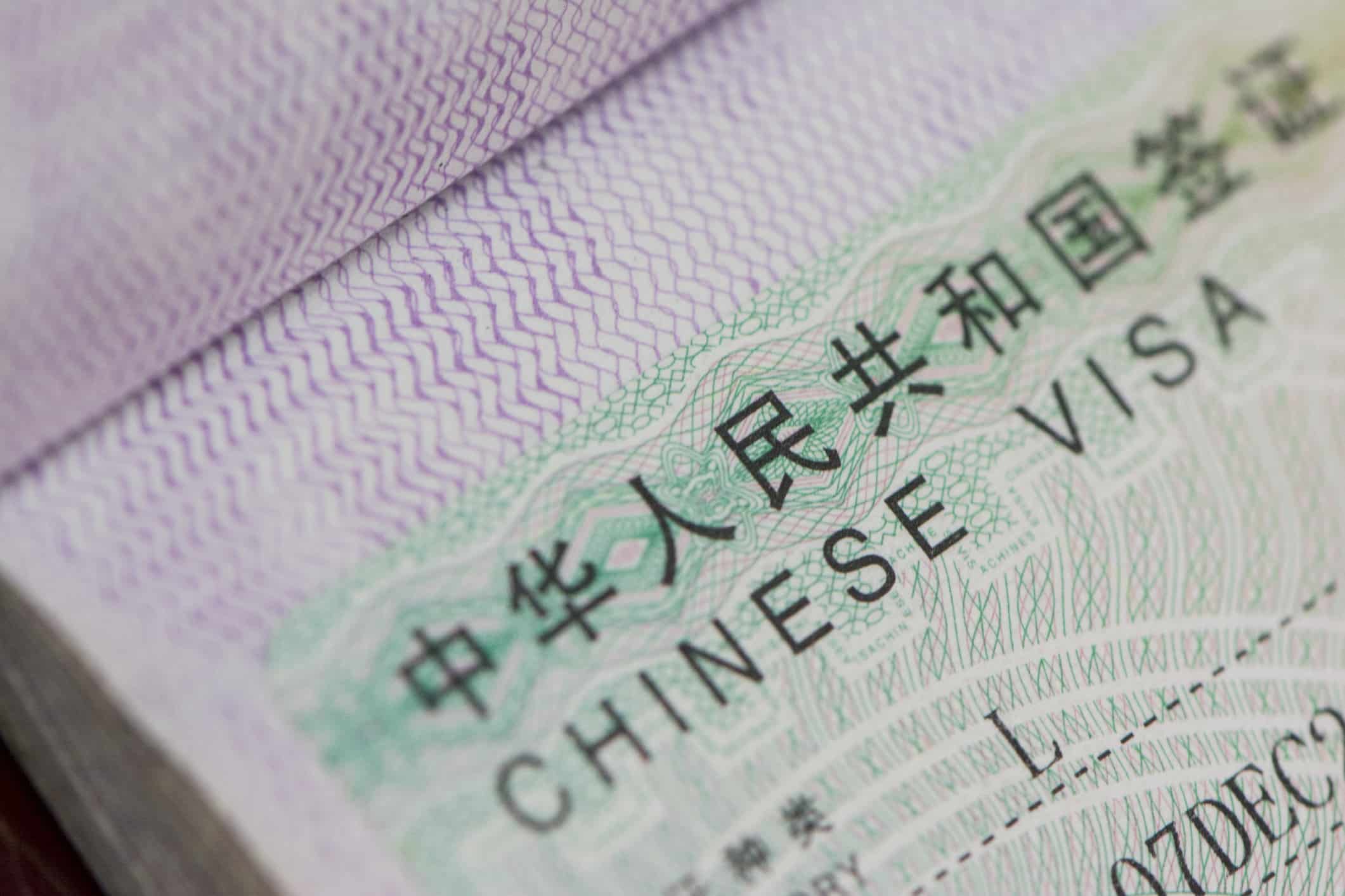 a close up of a passport with China Tourist L Visa