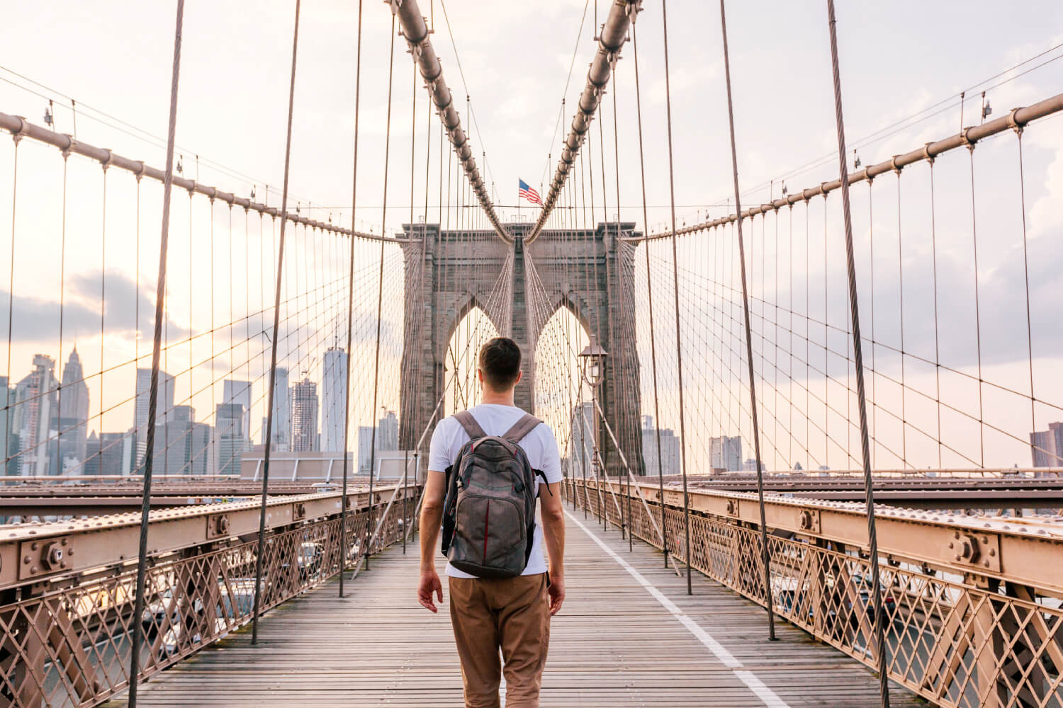 a man walking on a New York bridge